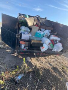 junk removal being dumped out of trailer